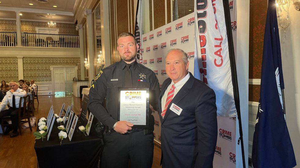 Deputy Johnathan Hill receiving the James Russel Sorrow Memorial Award from Crime Stoppers of Greenville Vice President Chuck Thomas