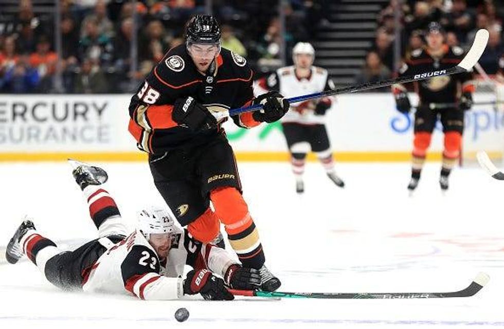 Derek Grant evades a defenseman as he chases down the puck.