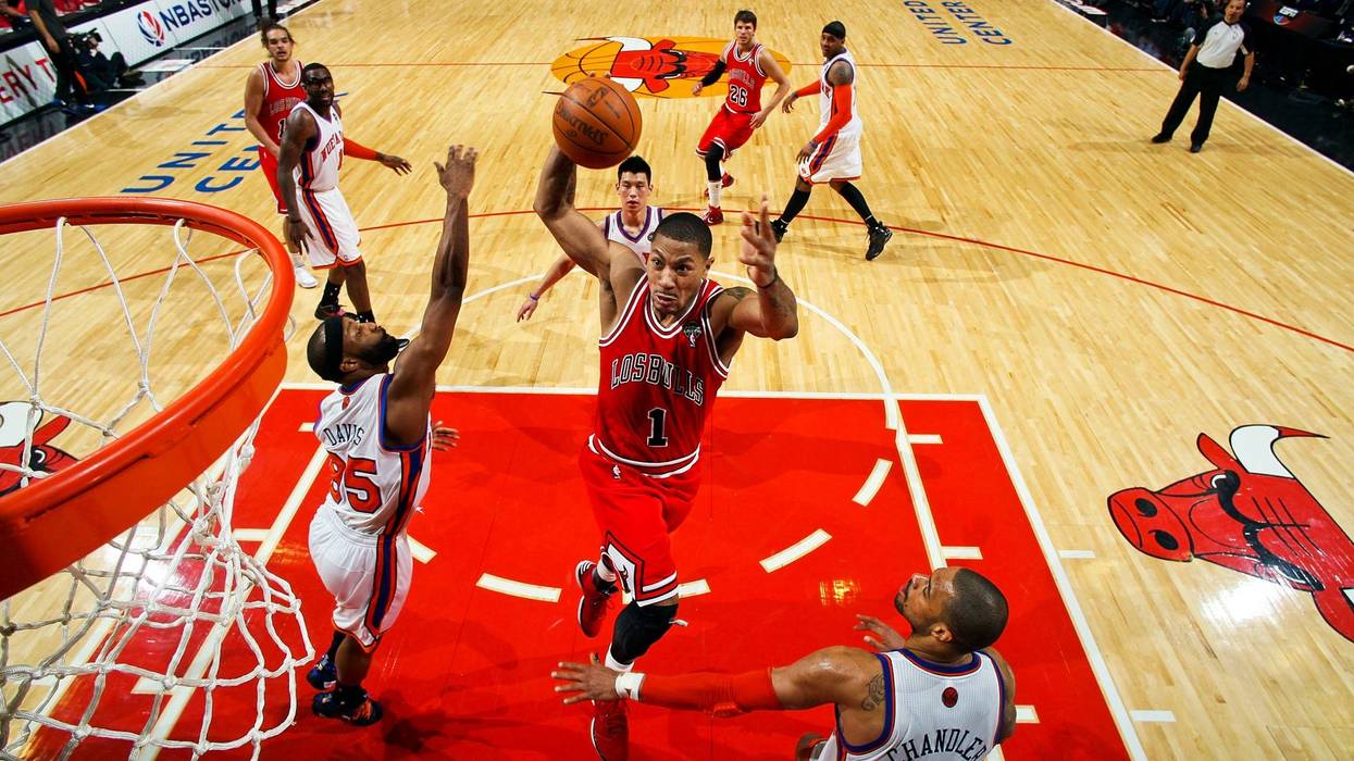 Derrick Rose, of the Chicago Bulls, dunks against Baron Davis and Tyson Chandler, of the New York Knicks, on March 12, 2012 at the United Center in Chicago. As Stacey King famously stated during a different Bulls game: "Derrick Rose can go upstairs."
