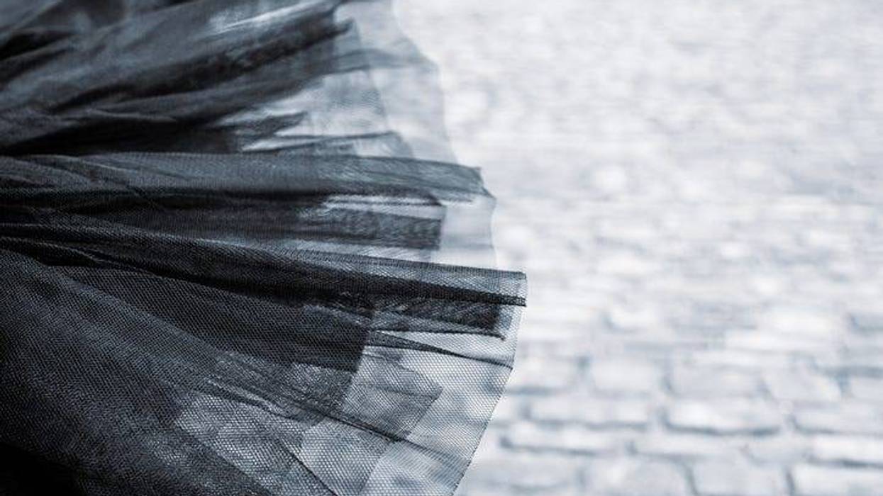 Detail of a Black tutu laying on the cobblestone