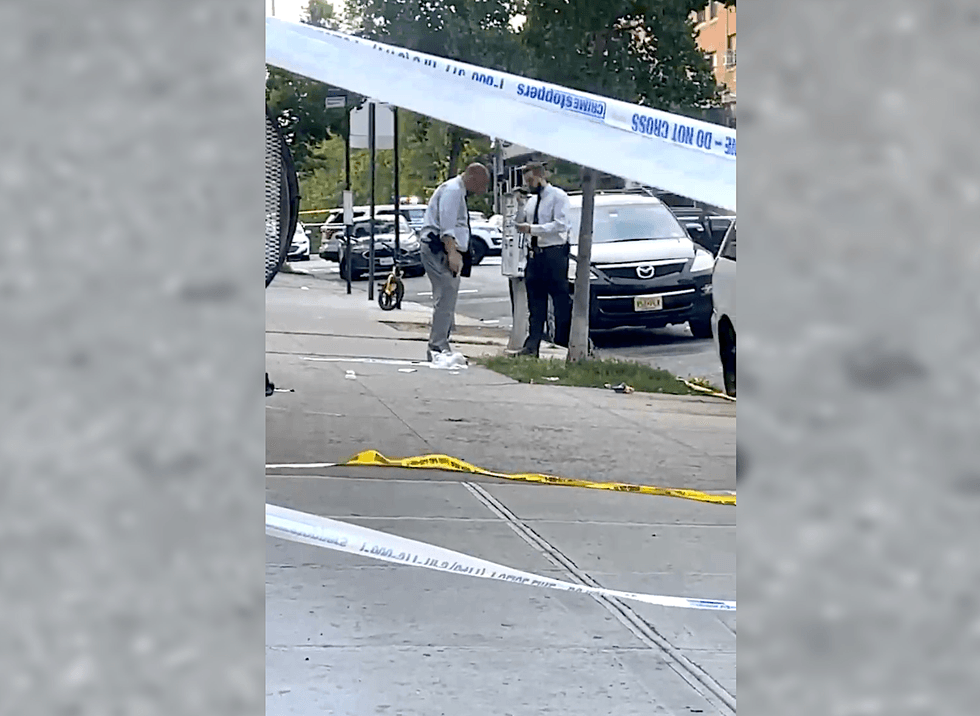 Detectives investigate at the scene of a shooting that left a 16-year-old boy dead in Bedford-Stuyvesant on June 19