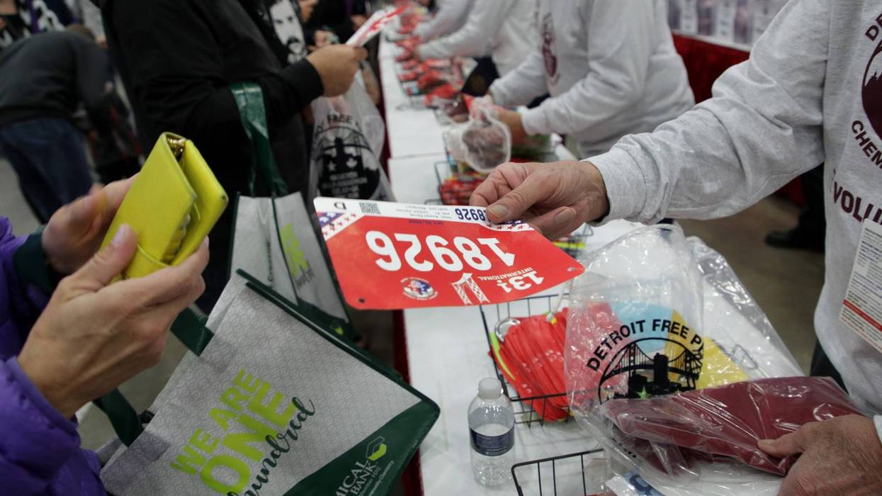Detroit Free Press Marathon runner gets bib at Health & Fitness Expo at Huntington Place.