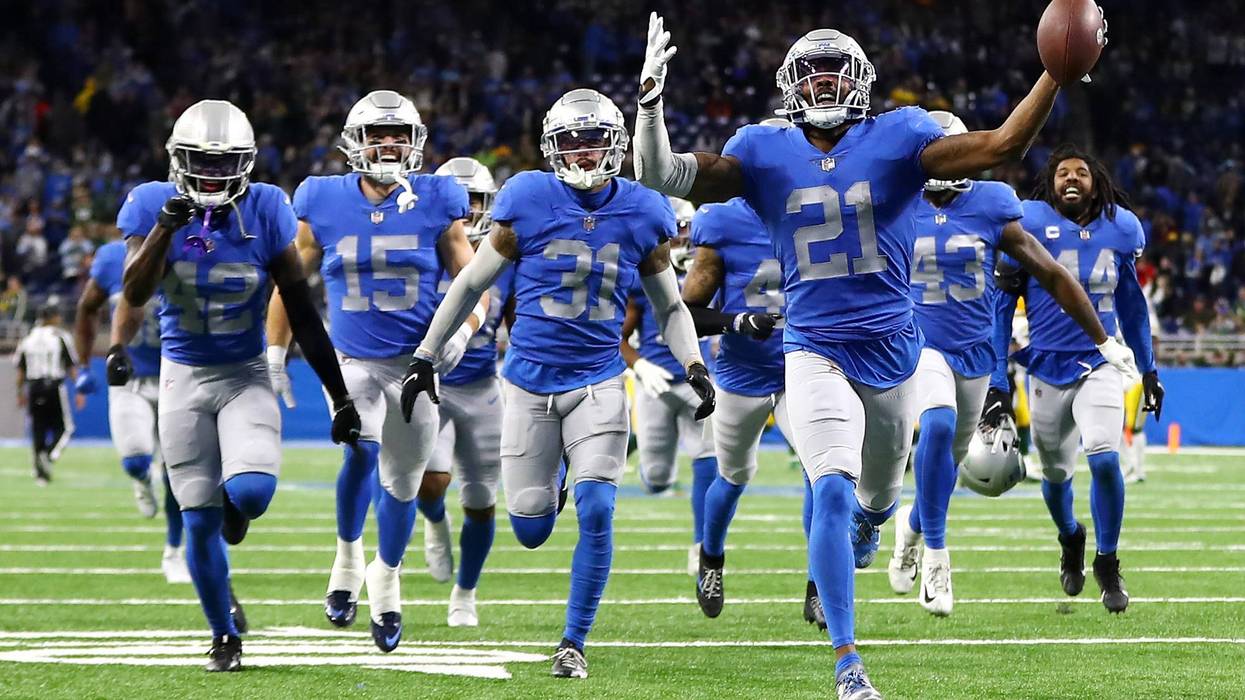 Detroit Lions players on the turf at Ford Field