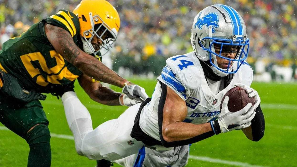 Detroit Lions wide receiver Amon-Ra St. Brown (14) makes a catch for a touchdown against Green Bay Packers cornerback Keisean Nixon (25) during the first half at Lambeau Field in Green Bay, Wis. on Sunday, Nov. 3, 2024.