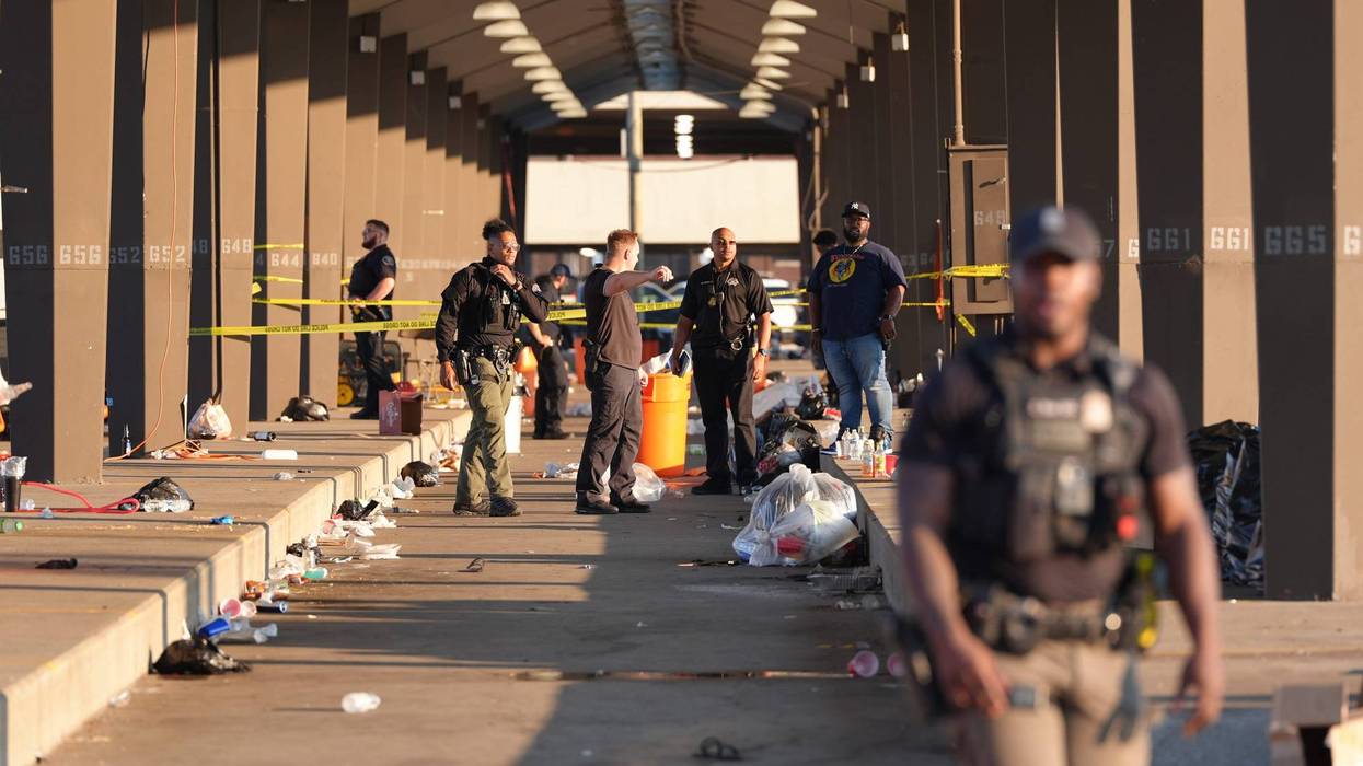 Detroit police investigate the scene where two people were shot following a fight in Eastern Market at a tailgating party for the Detroit Lions