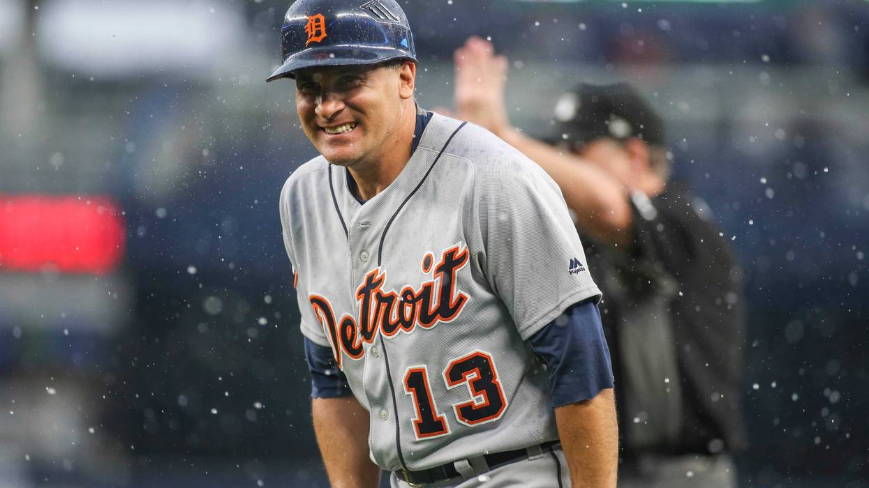 Detroit Tigers first base coach Omar Vizquel (13) reacts in the rain in the seventh inning against the New York Yankees at Yankee Stadium.