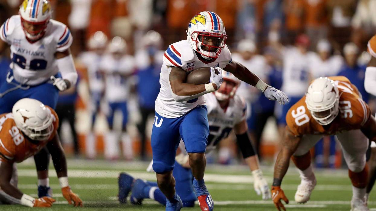 Devin Neal #4 of the Kansas Jayhawks rushes for a touchdown in the third quarter against the Texas Longhorns.