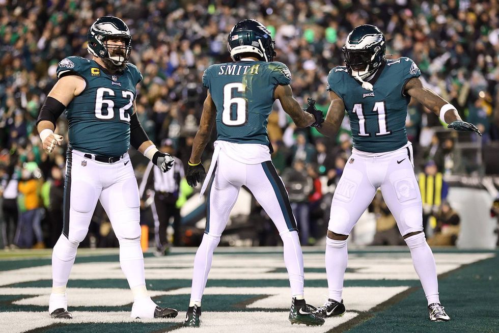 DeVonta Smith of the Philadelphia Eagles celebrates his touchdown with teammate Jason Kelce and A.J. Brown during the first quarter against the New York Giants in the NFC Divisional Playoff game at Lincoln Financial Field on Jan. 21, 2023 in Philadelphia, Pennsylvania.