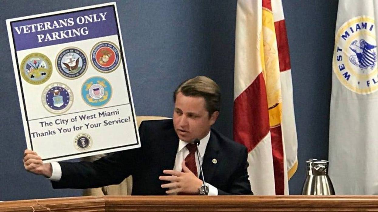 Diaz-Padron hols up veterans parking sign