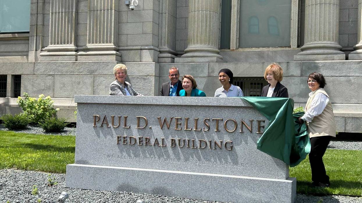 Dignitaries including Rep. Ilhan Omar and Senators Amy Klobuchar and Tina Smith, show off the new name of a Minneapolis Federal Building named for the late Senator from Minnesota, Paul Wellstone, who died in 2002.