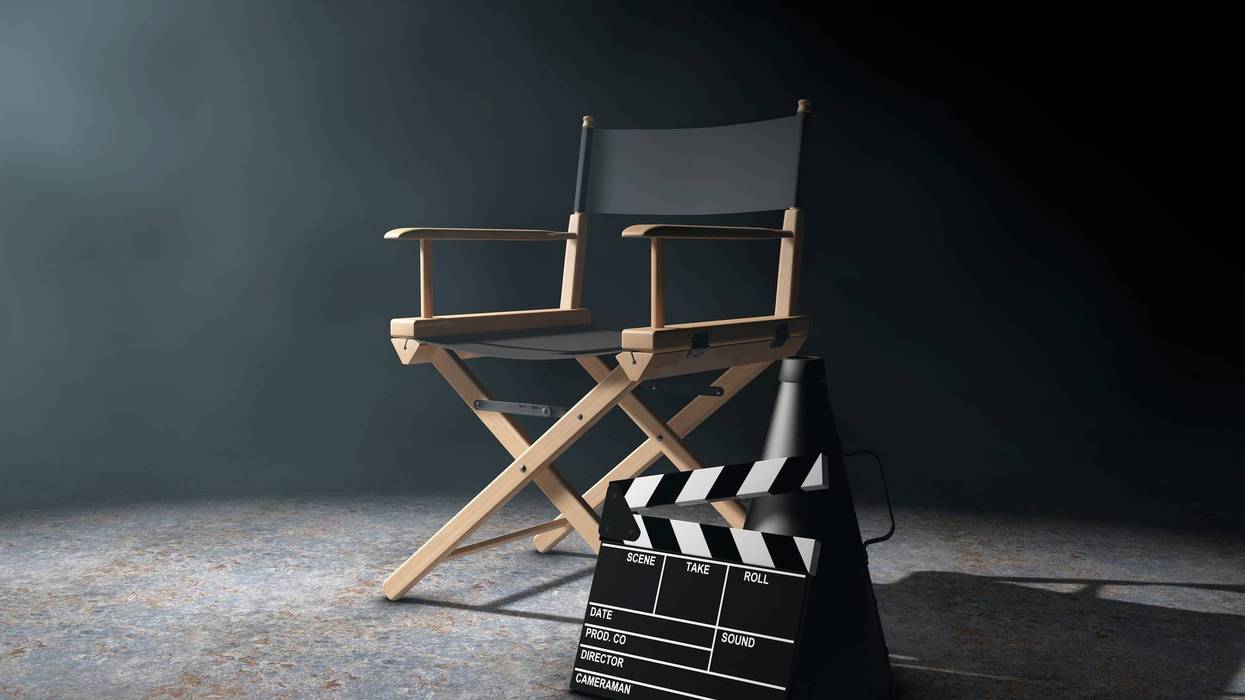 Director Chair, Movie Clapper and Megaphone in the volumetric light on a black background.