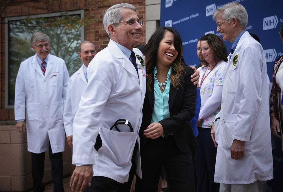 Director of the National Institute of Allergy and Infectious Diseases Anthony Fauci (3rd L) leaves with Nina Pham (4th L), the nurse who was infected with Ebola from treating patient Thomas Eric Duncan, as Director of the National Institutes of Health Francis Collins (L) looks on after a news briefing at National Institutes of Health October 24, 2014 in Bethesda, Maryland.