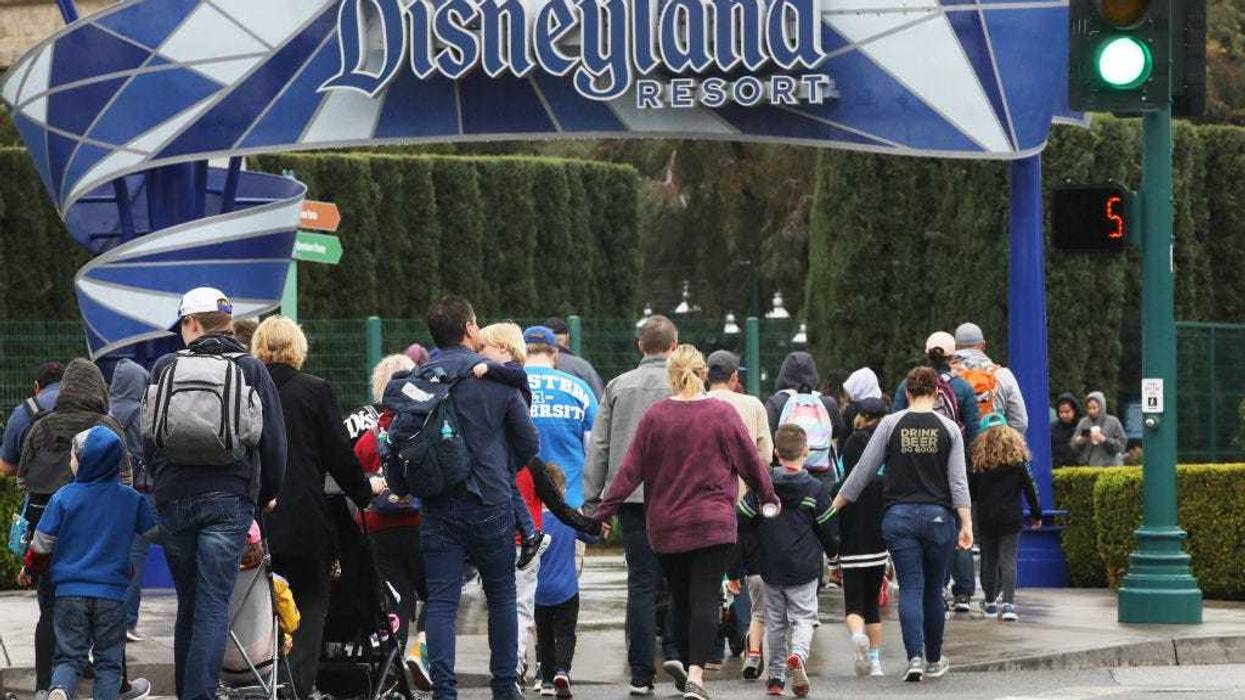 Disneyland visitors enter the famed amusement park on March 13, 2020, in Anaheim, California.