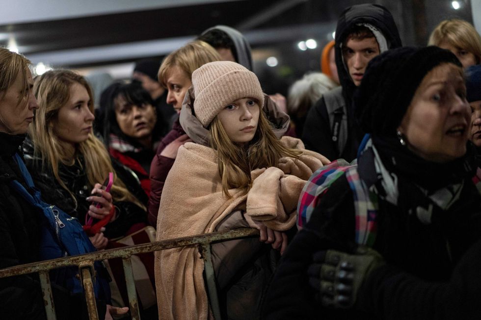 Displaced people queue to get on a train to Poland, inside Lviv railway station, in Lviv, western Ukraine, Thursday, March 3, 2022