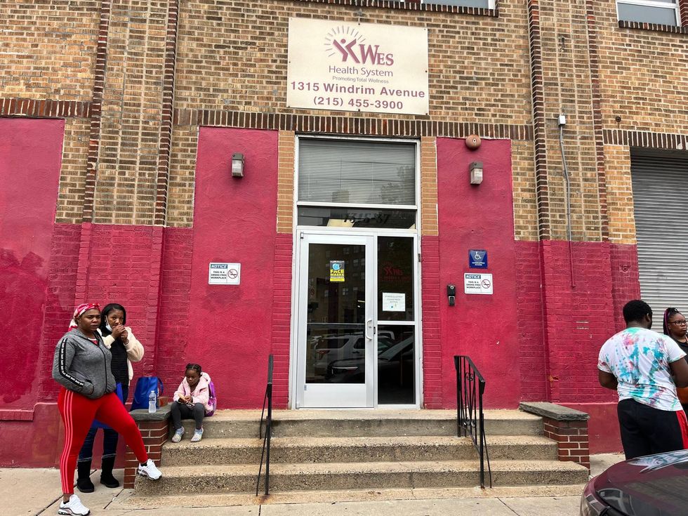 Displaced residents of Lindley Towers outside of a community center where they are receiving help, one month after the building in Logan partially collapsed.