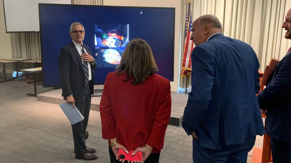 District Attorney Larry Krasner shows photos of the evidence to City Council members from the Kensington caucus: Quetcy Lozada, Mark Squilla and Jim Harrity.