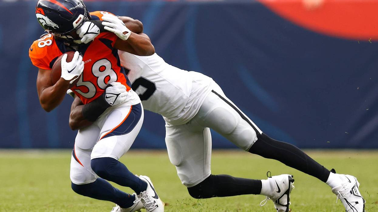 Divine Deablo #5 of the Las Vegas Raiders grabs the face mask of Jaleel McLaughlin #38 of the Denver Broncos during the second quarter at Empower Field At Mile High on September 10, 2023 in Denver