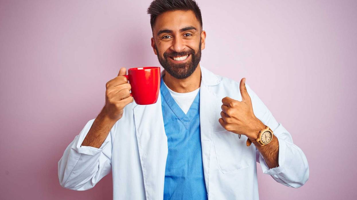 Doctor holding a cup of coffee.