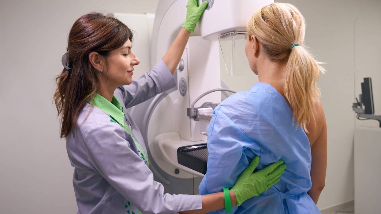 Doctor setting woman up for mammogram screening
