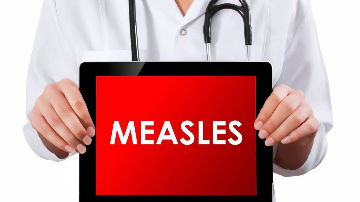 Doctor showing digital tablet screen.Measles