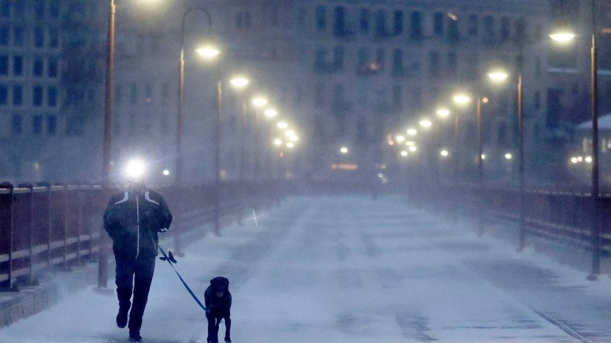 Dog walking in the cold on the Stone Arch Bridge