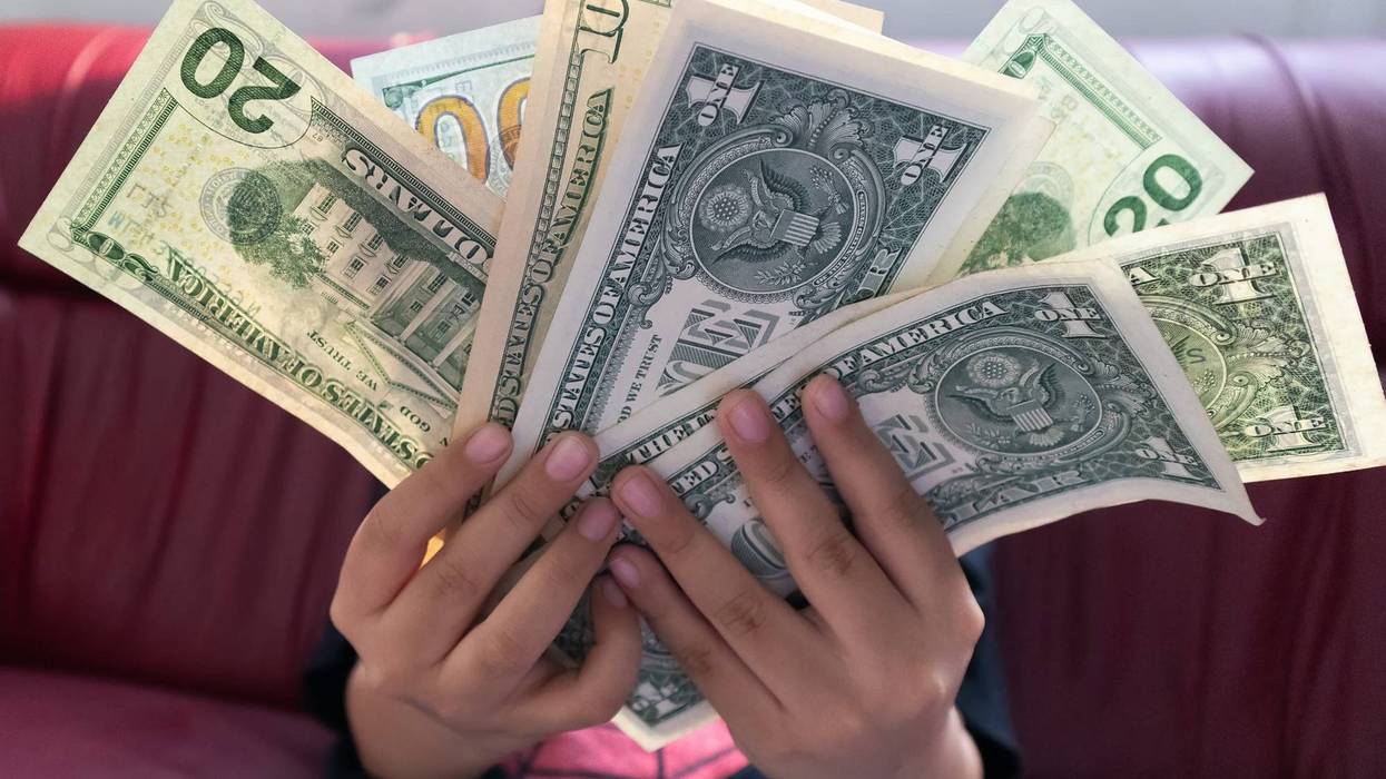 Dollar money banknote in young boy hand.Freelance Business making money and Internet shopping online concept