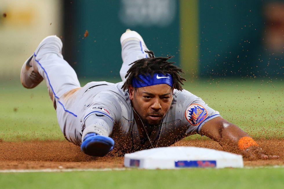 Dominic Smith diving safely into third base
