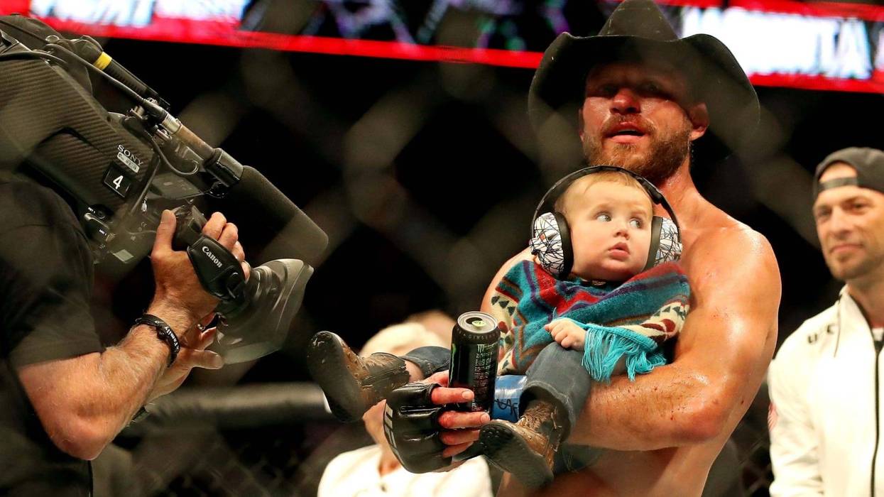 Donald "Cowboy" Cerrone holds his infant son after defeating Al Iaquinta at UFC Fight Night in Ottawa.