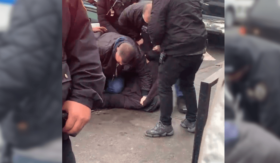 Donald Davis being arrested in Queens Friday.
