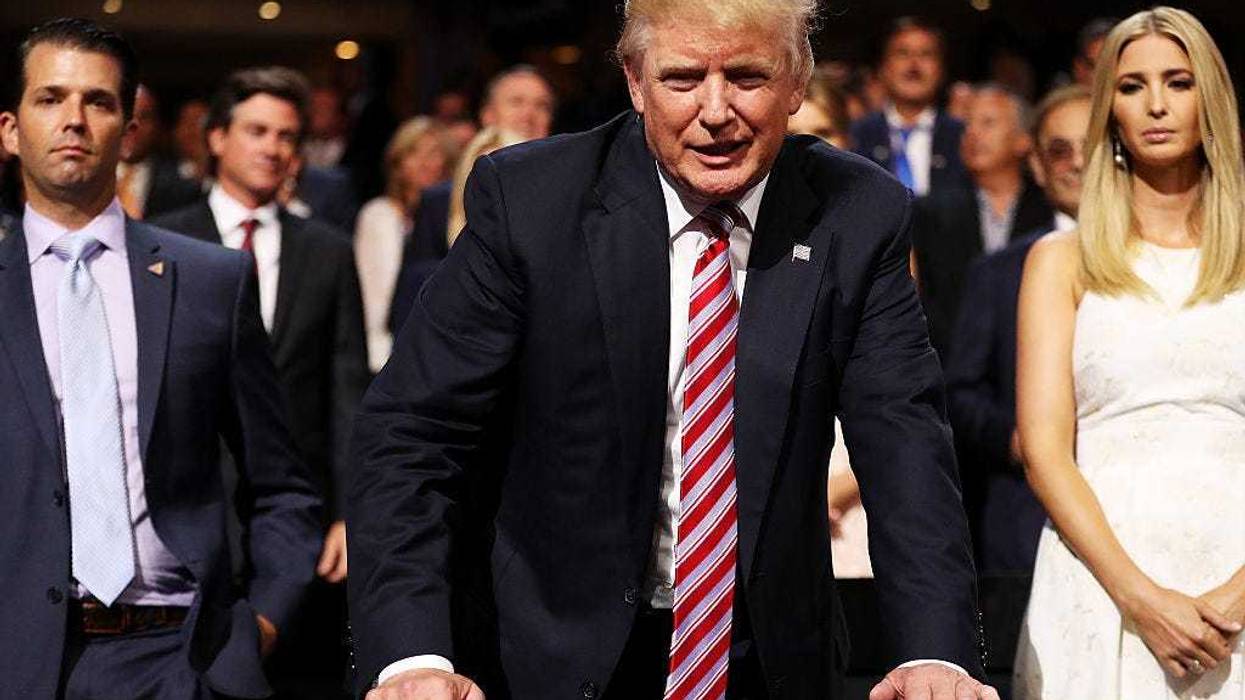 Donald Trump (C) speaks to delegates as Donald Trump Jr. (L) and Ivanka Trump (R) look on during the third day of the Republican National Convention on July 20, 2016 at the Quicken Loans Arena in Cleveland, Ohio.