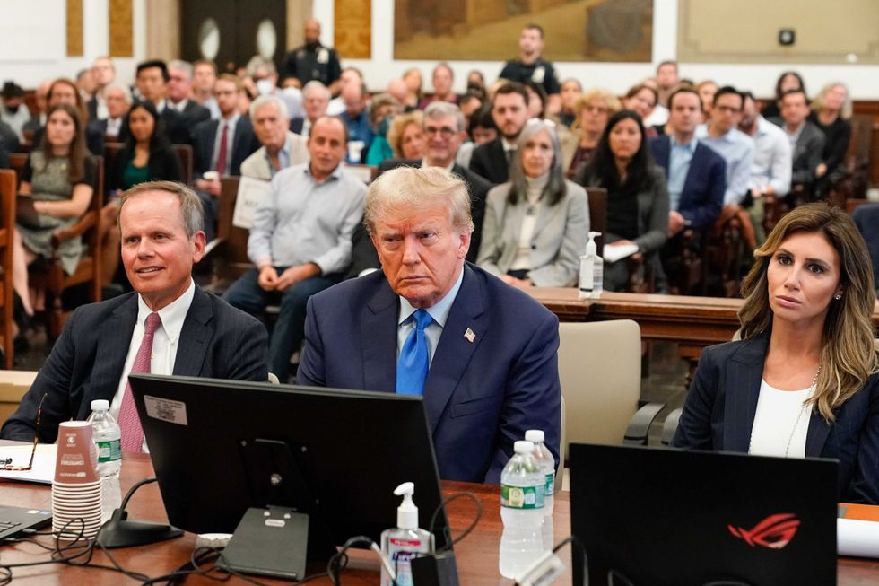 Donald Trump, center, sits in the courtroom at New York Supreme Court, Monday, Oct. 2, 2023