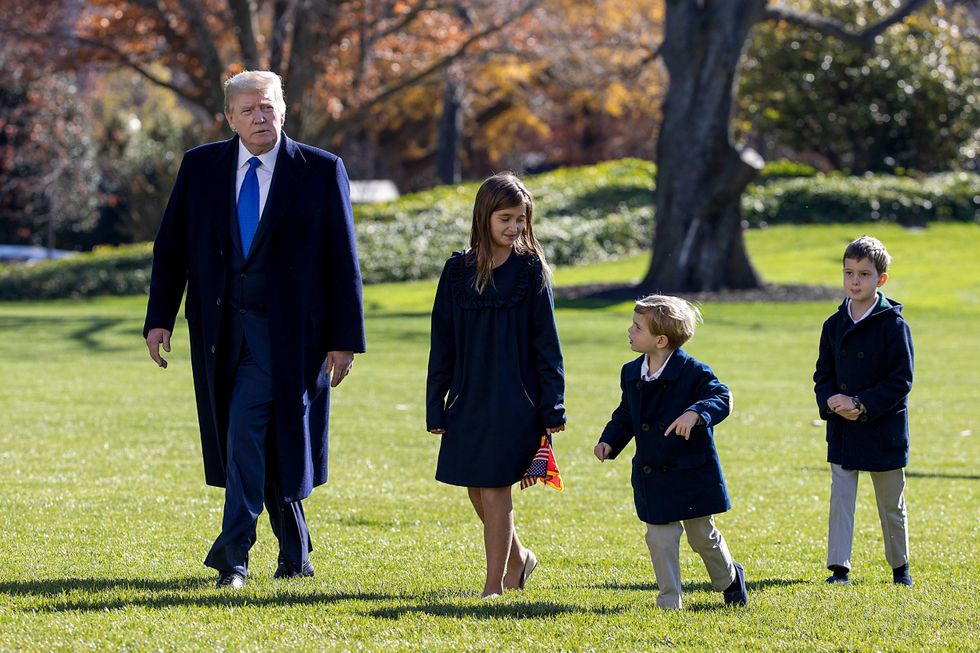 Donald Trump, followed by his grandchildren, Arabella Kushner, Theodore Kushner, and Joseph Kushner walk on the south lawn of the White House on November 29, 2020 in Washington, DC. President Trump spent the weekend at Camp David and at Trump National Golf Club in Sterling, Virginia.