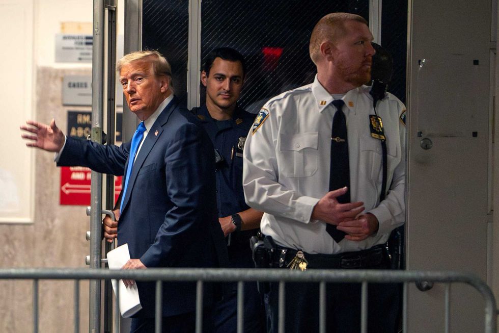Donald Trump gestures as he leaves court during his hush money trial at Manhattan Criminal Court on May 30, 2024