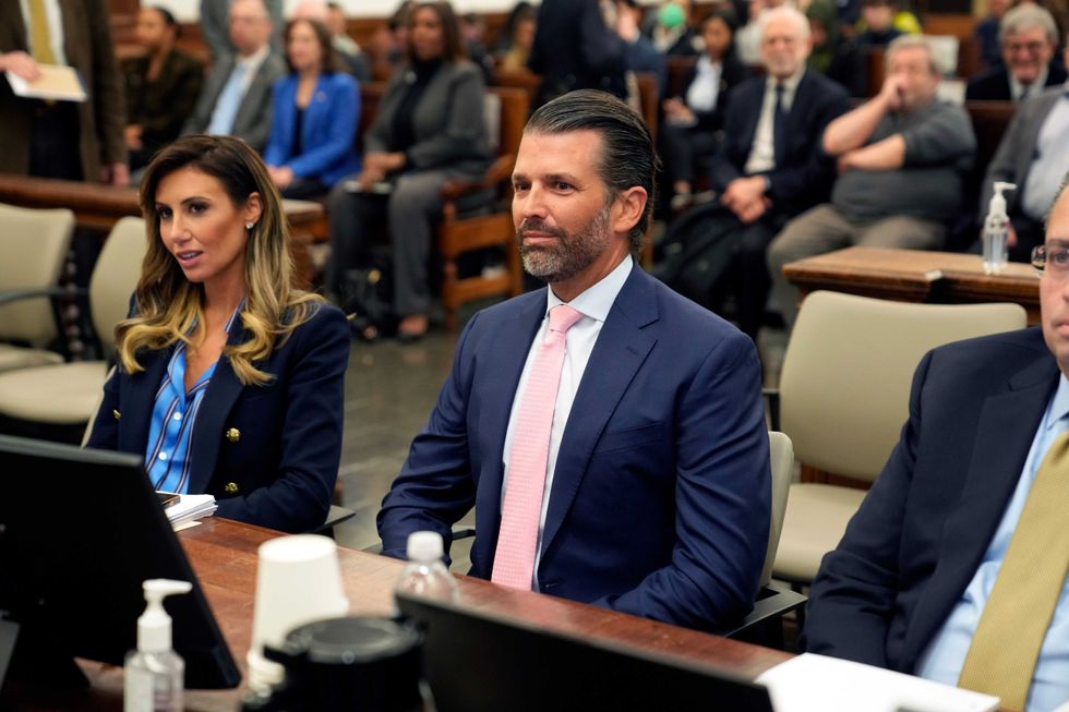 Donald Trump Jr. sits in a Lower Manhattan courtroom as lawyer Alina Habba listens (L) on Nov. 1, 2023