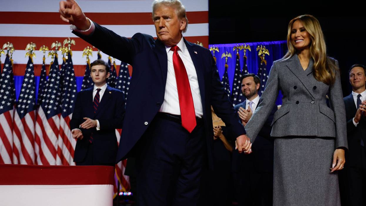 Donald Trump points to supporters with former first lady Melania Trump during an election night event at the Palm Beach Convention Center on November 06, 2024 in West Palm Beach, Florida.