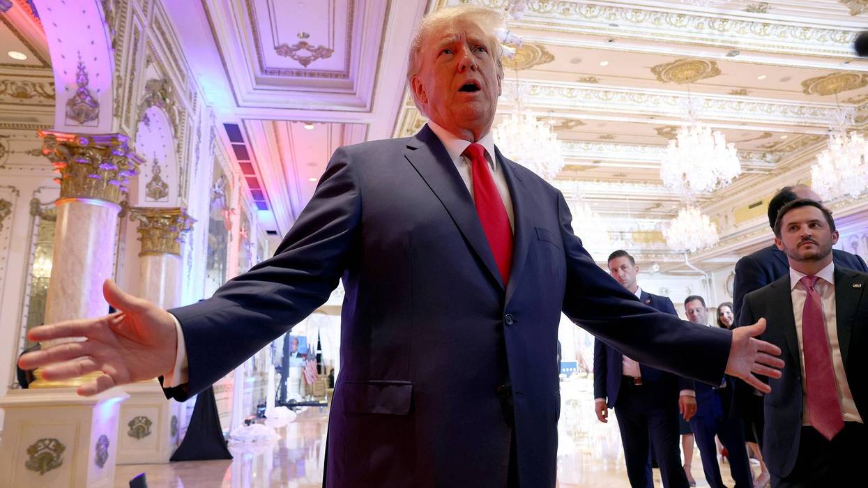 donald trump stands with his hands out