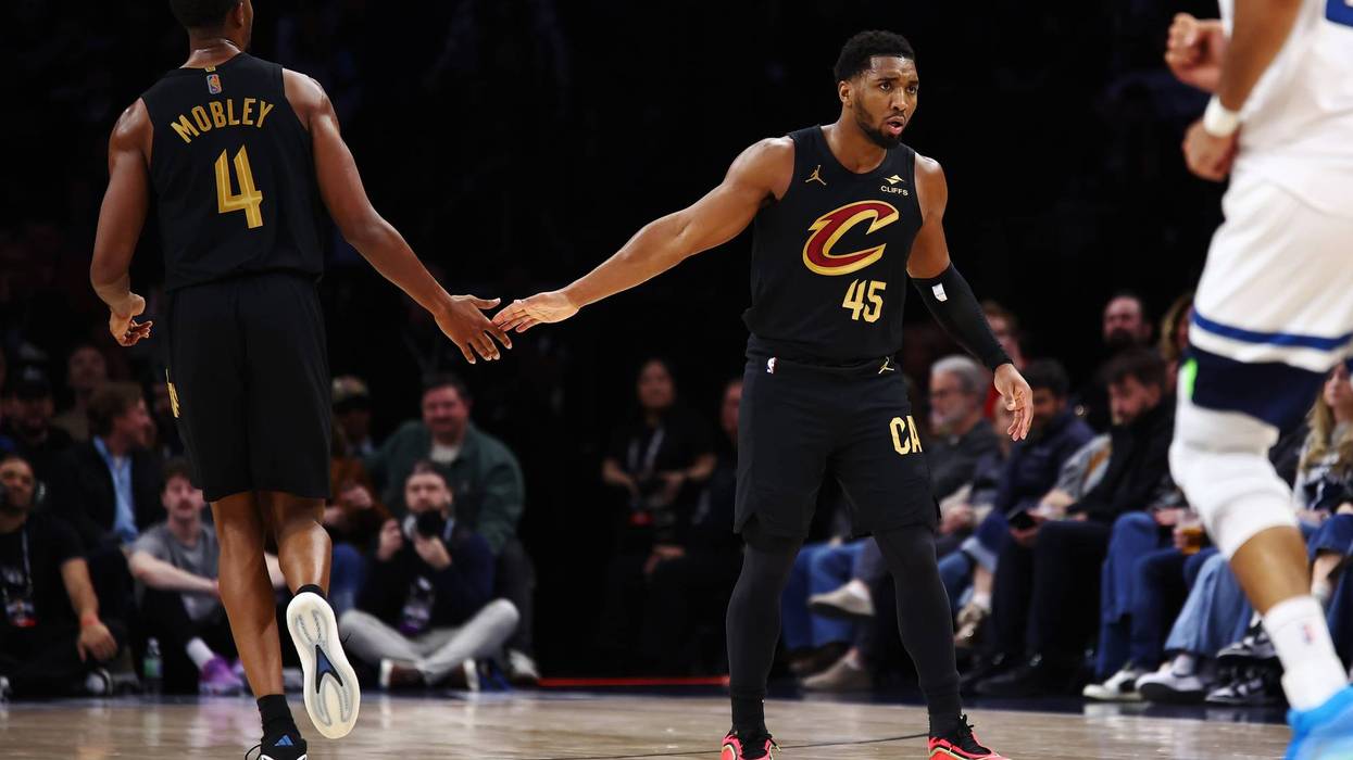 Donovan Mitchell #45 of the Cleveland Cavaliers high-fives Evan Mobley #4 during the second half at Target Center on January 08, 2026 in Minneapolis, Minnesota. The Timberwolves beat the Cavaliers 131-122.