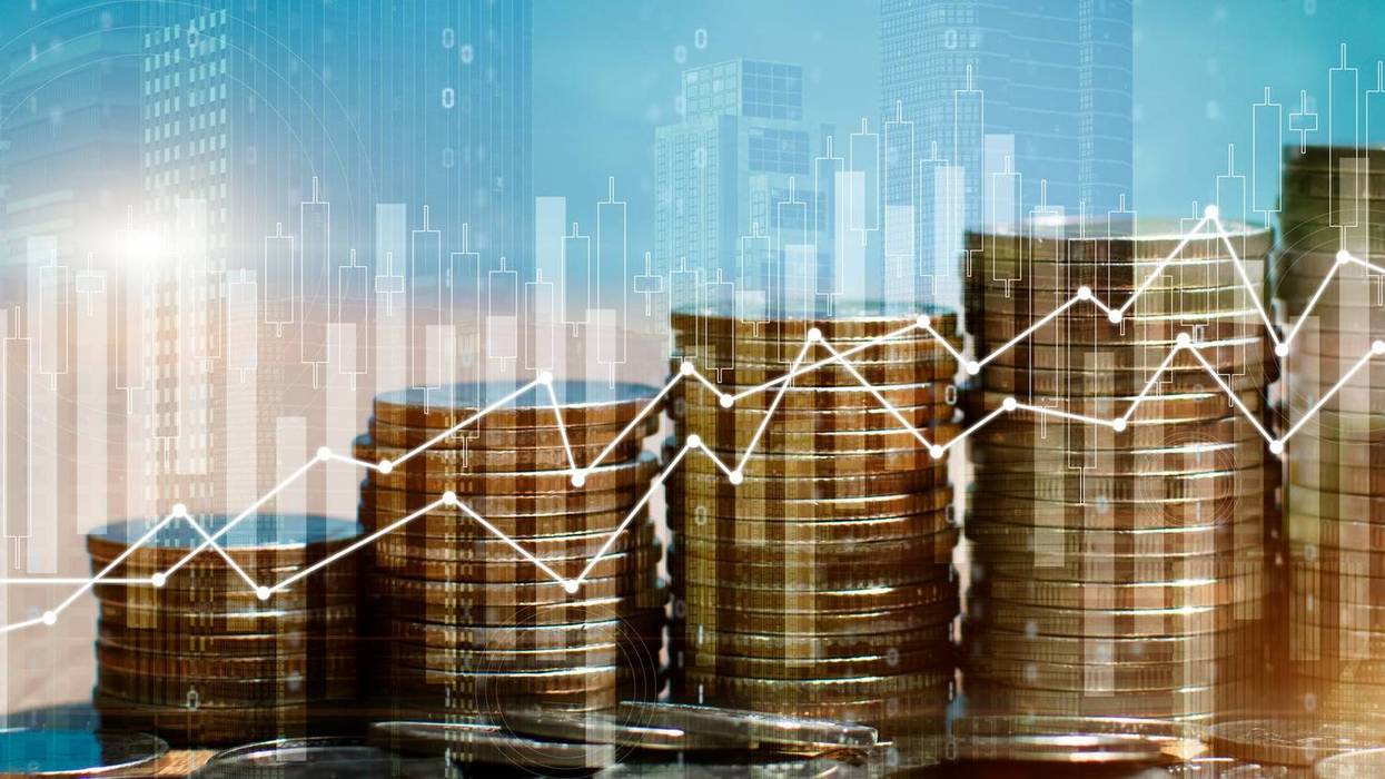 Double exposure of stack of money coin with trading graph for finance investor. Cryptocurrency digital economy. Financial investment and city background concept.