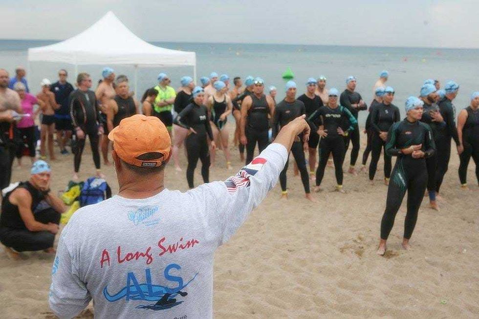 Doug McConnell directs a group of swimmers about to participate in one of A Long Swim