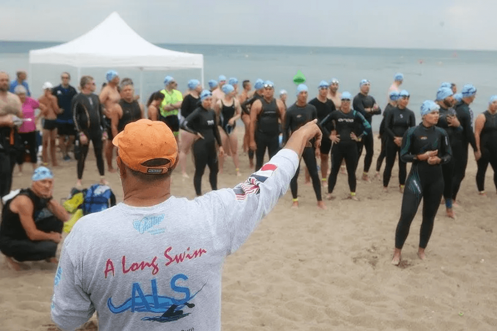 Doug McConnell, of the nonprofit A Long Swim, directs a group of swimmers about to participate in one of the organization