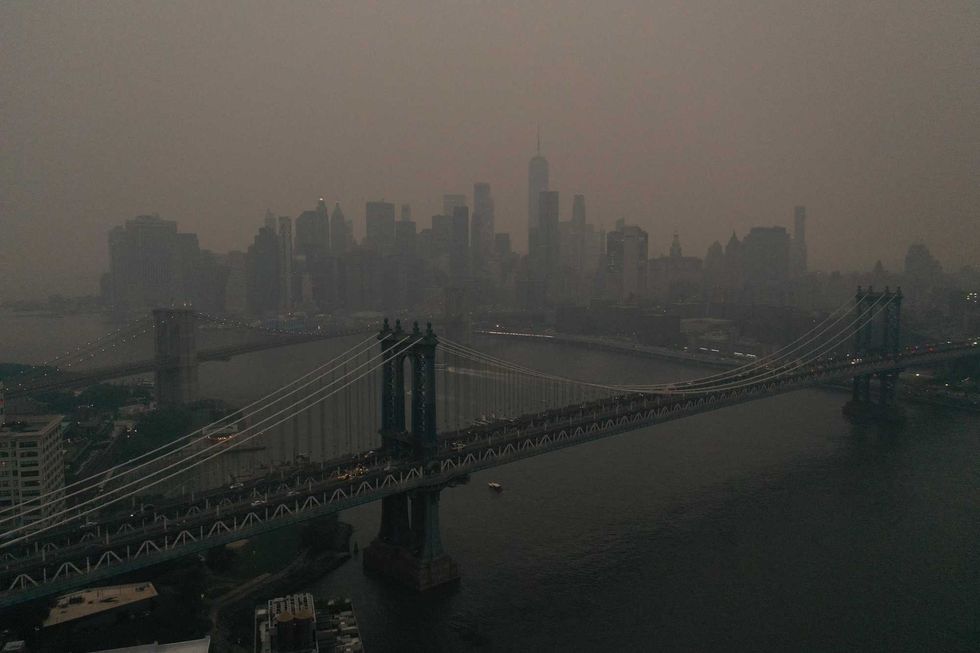 Downtown Manhattan stands shrouded in a reddish haze as a result of Canadian wildfires on June 6, 2023 in New York City