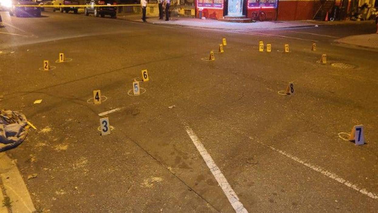 dozens of evidence markers in the street following a gang-related shooting