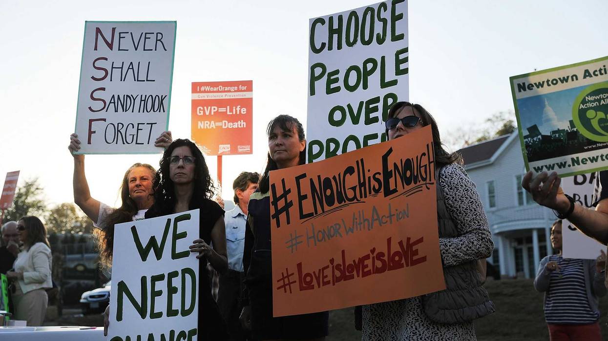 Dozens of people attend a vigil remembering the 58 people killed in the 2017 Las Vegas massacre and calling for action against guns on October 4, 2017 in Newtown, Connecticut.
