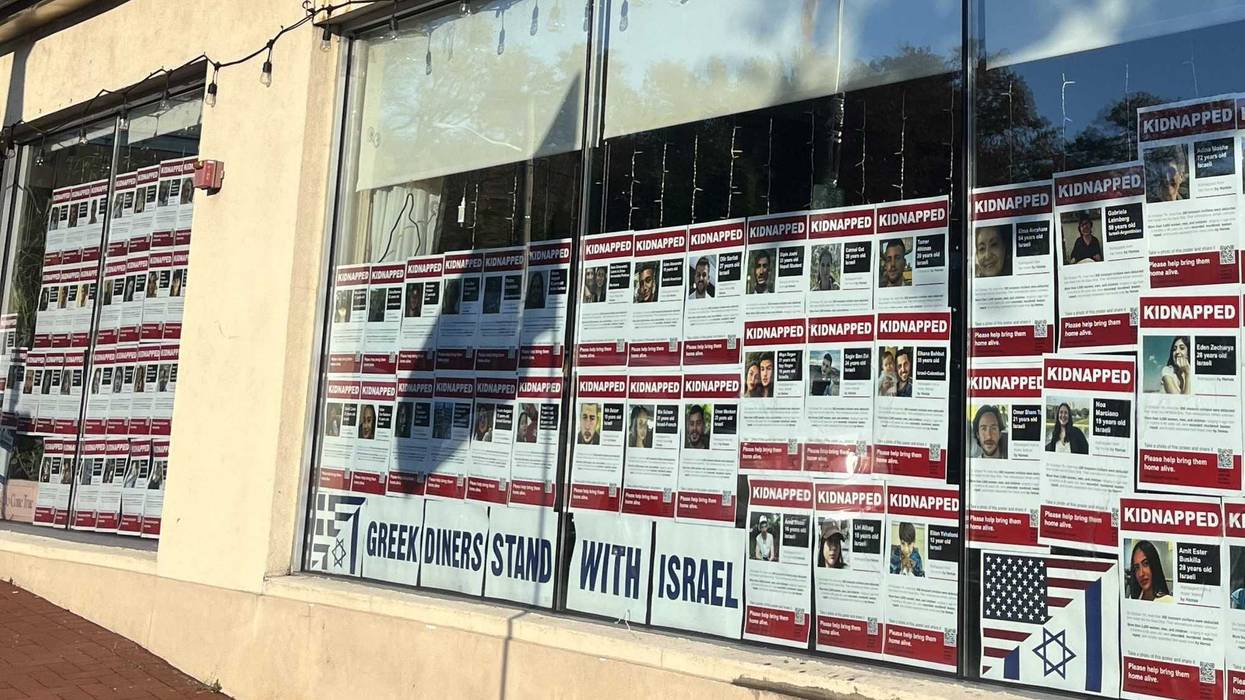 Dozens of posters of hostages and the sign "Greek diners stand with Israel" are seen in the window of the Golden Globe Diner in Huntington on Thursday