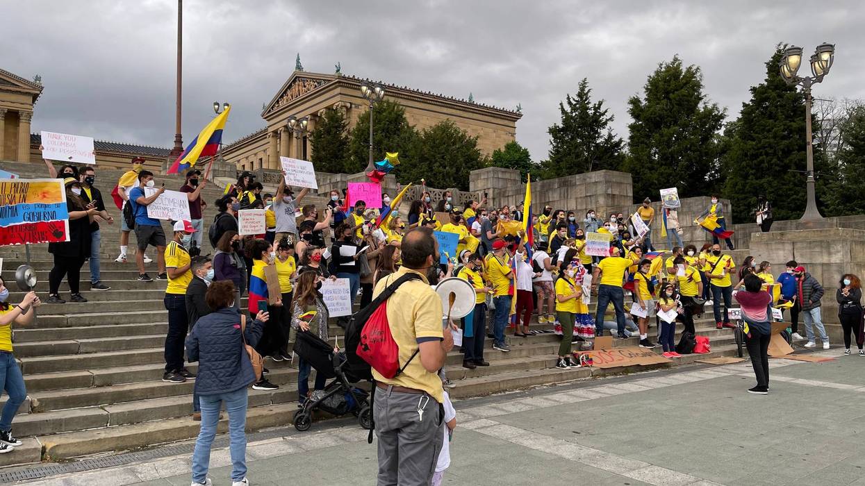 Dozens of protesters took to the Art Museum steps, dressed in yellow, red and blue — colors of the Colombian flag.