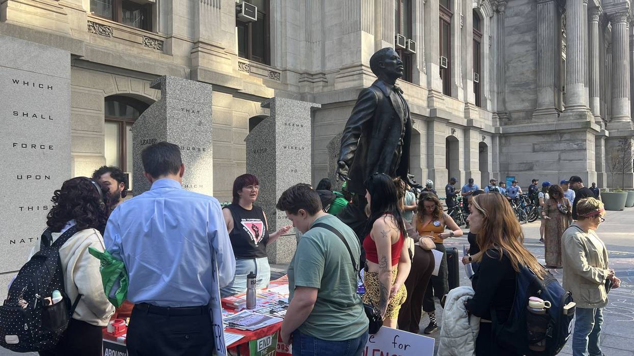 Dozens rallied with signs, chanted and shared survivor stories at City Hall, demanding more from colleges addressing sexual assault.