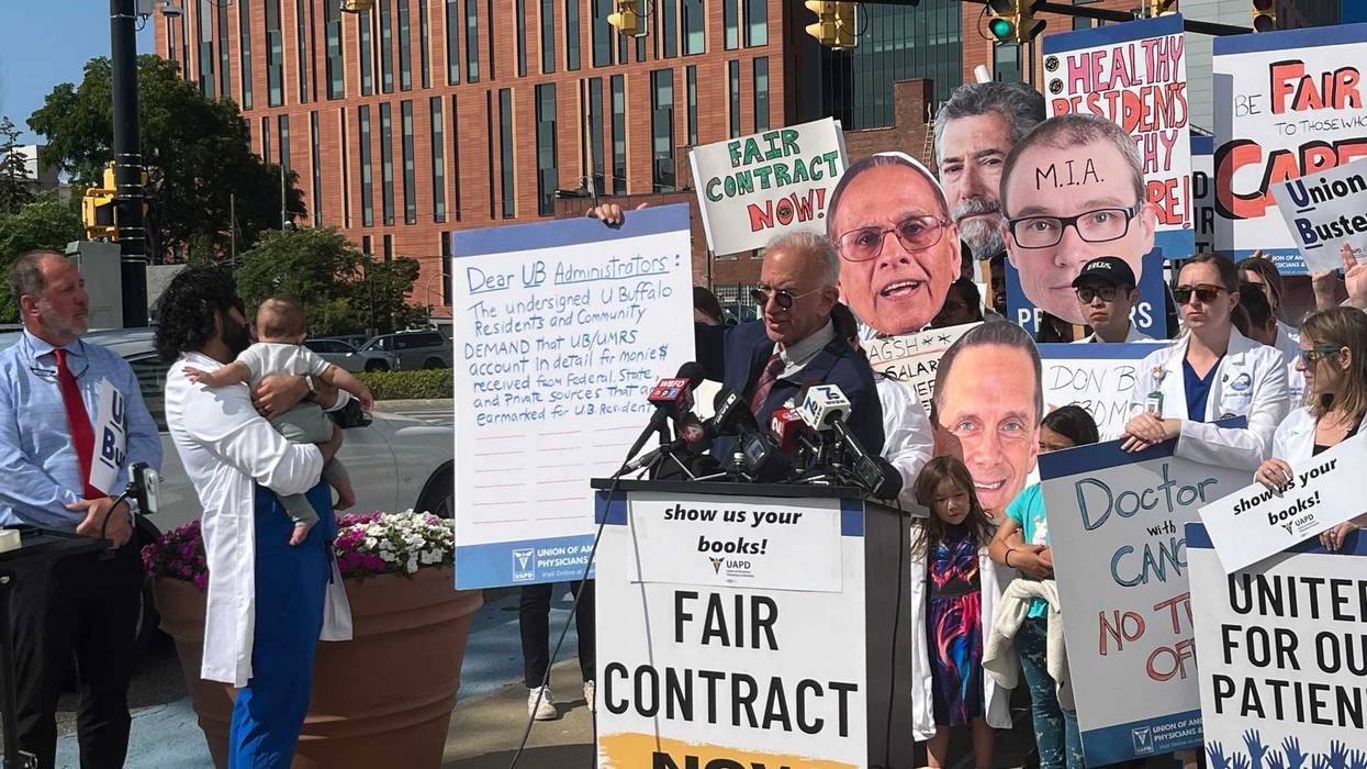 Dr. Gary Bussey holds up petition calling for transparency of our Buffalo healthcare systems.