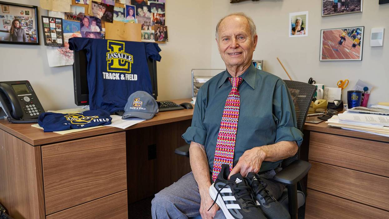 Dr. Joshua Buch holding running sneakers in his office