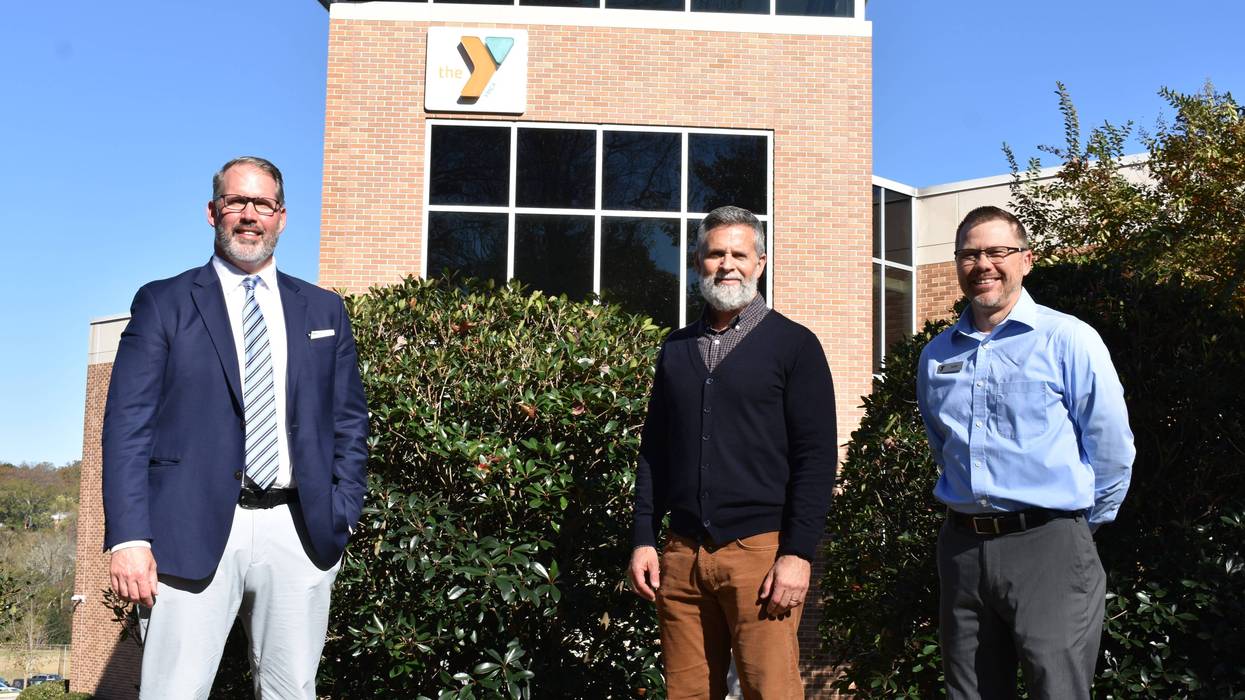 Dr. Larry Miller (GTC), Scot Baddley, and Sam Franklin (YMCA) in front of Caine Halter YMCA