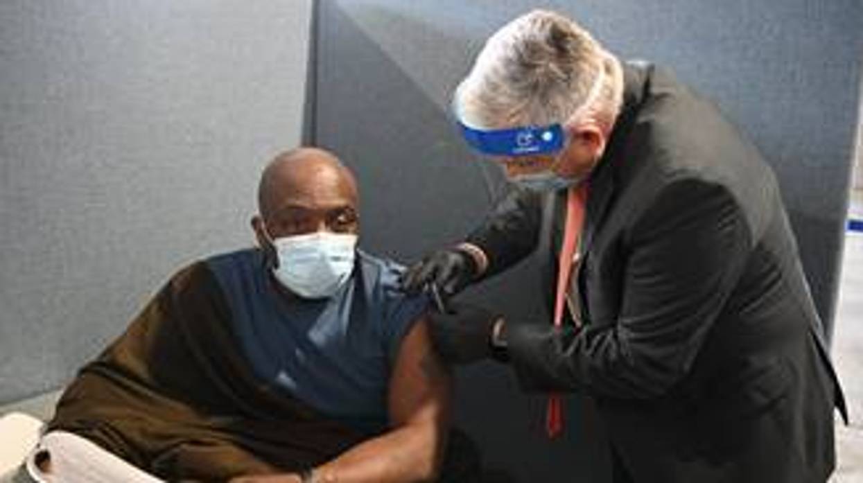 Dr. Richard Stone, Acting Under Secretary for Health, Veterans Health Administration, (right) administers a COVID-19 vaccine to a New York-area veteran. Dr. Stone recently visited a mass vaccination clinic in Yonkers, N.Y. as part of VA's Fourth Mission activities.